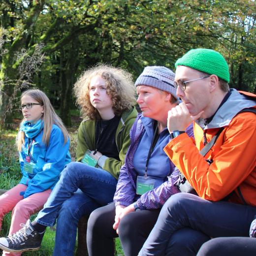 Living as a Quaker image Two adults and young people sitting together
